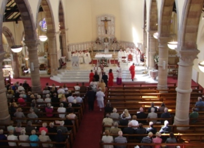 Margaret and family members bring the gifts to the altar.